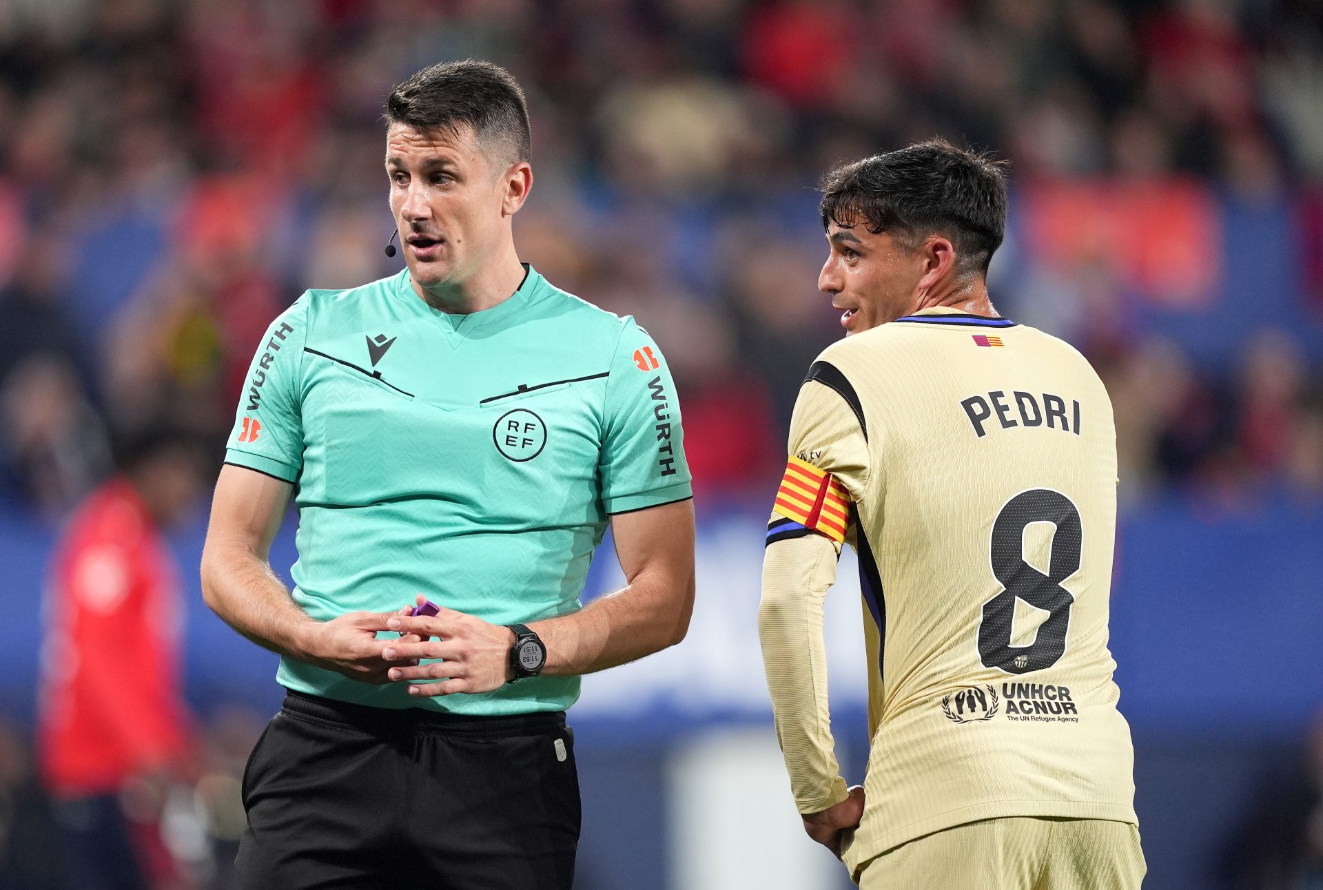 Referee Isidro Diaz de Mera Escuderos and Pedri of FC Barcelona